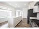 This open kitchen features a long counter top and views to the living room at 19800 Sutton Ter, Westfield, IN 46074