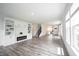 Spacious living room with a fireplace, built-in shelving, and hardwood floors at 19800 Sutton Ter, Westfield, IN 46074