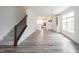 Open-concept living area with hardwood floors, staircase, and natural light at 19800 Sutton Ter, Westfield, IN 46074