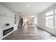 Spacious open-concept living area featuring hardwood floors and a fireplace at 19800 Sutton Ter, Westfield, IN 46074