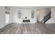 Beautiful living room with modern fireplace, built-in shelving, and hardwood floors at 19800 Sutton Ter, Westfield, IN 46074
