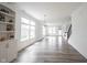 Bright and open living room with large windows, wood floors, and built-in shelving at 19800 Sutton Ter, Westfield, IN 46074