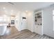 Bright, open-concept living space featuring hardwood floors, modern white trim and an entry door at 19800 Sutton Ter, Westfield, IN 46074