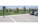 Golf cart parking lot with marked spaces, situated near tennis court and attractive landscaping at 19800 Sutton Ter, Westfield, IN 46074