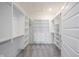 A spacious walk-in closet with ample shelving, drawer space and plush carpeting at 19800 Sutton Ter, Westfield, IN 46074