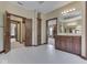 Spacious bathroom featuring white tile floors, wooden cabinets, and well-lit mirrors at 20 Forrests Edge Ct, Indianapolis, IN 46227