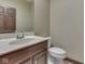 Half bathroom features a modern toilet, vanity and faucet at 20 Forrests Edge Ct, Indianapolis, IN 46227