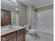 Well-lit bathroom featuring a vanity with dark wood cabinets and a shower-over-tub combo at 20 Forrests Edge Ct, Indianapolis, IN 46227