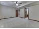 Spacious bedroom with neutral carpeting and trim, featuring a ceiling fan and access to other rooms at 20 Forrests Edge Ct, Indianapolis, IN 46227