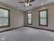 Bedroom with three large windows offering natural light and views of mature trees at 20 Forrests Edge Ct, Indianapolis, IN 46227