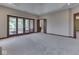 Spacious bedroom features sliding doors to a screened-in porch and neutral carpeting at 20 Forrests Edge Ct, Indianapolis, IN 46227