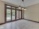 Bright dining room with tiled floors, chandelier, and doors leading to a deck at 20 Forrests Edge Ct, Indianapolis, IN 46227
