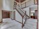 Spacious foyer featuring a staircase with white railings and a view of an adjacent room with built-in shelves at 20 Forrests Edge Ct, Indianapolis, IN 46227