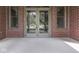 Elegant front door with glass panels and a transom window, framed by brick walls and side windows at 20 Forrests Edge Ct, Indianapolis, IN 46227