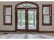 Interior view of elegant double doors with decorative trim and windows, offering a view of the front yard at 20 Forrests Edge Ct, Indianapolis, IN 46227