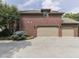 Attached three-car garage featuring brick facade and a concrete driveway with mature trees at 20 Forrests Edge Ct, Indianapolis, IN 46227