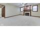 Spacious carpeted living room featuring a fireplace and access to another room at 20 Forrests Edge Ct, Indianapolis, IN 46227