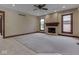 Comfortable living room with a stone fireplace, neutral carpet, and ceiling fan at 20 Forrests Edge Ct, Indianapolis, IN 46227