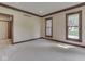 Neutral living room with windows, carpet, and dark trim at 20 Forrests Edge Ct, Indianapolis, IN 46227