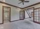 Living room with neutral carpet, decorative glass doors, and dark trim, leading to a staircase at 20 Forrests Edge Ct, Indianapolis, IN 46227