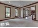 Bright living room with three large windows, neutral carpet, and dark trim at 20 Forrests Edge Ct, Indianapolis, IN 46227