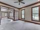 Bright living room featuring neutral carpet, brown trim, and large windows providing plenty of natural light at 20 Forrests Edge Ct, Indianapolis, IN 46227