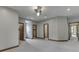 Spacious main bedroom with ensuite, featuring a ceiling fan, recessed lighting, and three doorways at 20 Forrests Edge Ct, Indianapolis, IN 46227