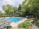 Backyard pool featuring a diving board, waterfall and mature landscaping at 20 Forrests Edge Ct, Indianapolis, IN 46227