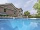 Swimming pool view including brick home exterior and upper level sunroom at 20 Forrests Edge Ct, Indianapolis, IN 46227