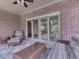 Covered porch with brick accent wall, wicker furniture, and an area rug at 20 Forrests Edge Ct, Indianapolis, IN 46227