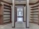Expansive walk-in closet with built-in wooden shelves and neutral carpeting at 20 Forrests Edge Ct, Indianapolis, IN 46227