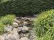 A soothing rock waterfall feature adds tranquility to the outdoor space at 20 Forrests Edge Ct, Indianapolis, IN 46227