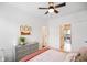 Comfortable bedroom with neutral carpet, modern dresser, and a view to an outdoor deck at 2125 Coretta Way, Indianapolis, IN 46202