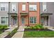 Inviting exterior featuring manicured landscaping, red brick facade, and covered entryways with muted accents at 2125 Coretta Way, Indianapolis, IN 46202