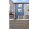 View of townhomes with gray, blue, and gray siding, garages, and a balcony with a dark metal rail at 2125 Coretta Way, Indianapolis, IN 46202
