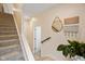 Inviting hallway featuring carpeted stairs, decorative accents, and natural light at 2125 Coretta Way, Indianapolis, IN 46202