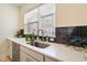 Close up of kitchen sink, counter, and accent tiling at 2125 Coretta Way, Indianapolis, IN 46202