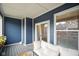 Inviting covered patio with comfortable seating, blue siding, and a relaxing atmosphere at 2125 Coretta Way, Indianapolis, IN 46202