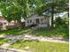 Charming single-story home with a cozy front yard and mature trees providing ample shade at 239 N 6Th Ave, Beech Grove, IN 46107
