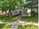 Charming single-story home with a cozy front yard and mature trees providing ample shade at 239 N 6Th Ave, Beech Grove, IN 46107