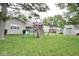 Large backyard with playground equipment, shed, and lush green lawn at 254 Bittersweet Dr, Whiteland, IN 46184