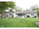 Large backyard with playground equipment and patio with table and chairs at 254 Bittersweet Dr, Whiteland, IN 46184