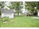 Expansive backyard featuring a play set, shed, patio with seating, and lush green lawn at 254 Bittersweet Dr, Whiteland, IN 46184
