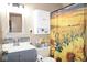 Bathroom with a sunflower shower curtain, modern sink, and storage cabinet at 254 Bittersweet Dr, Whiteland, IN 46184