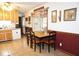 The dining area features a table setting, wood cabinets, and natural light creating an inviting place at 254 Bittersweet Dr, Whiteland, IN 46184