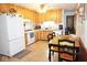 Efficient kitchen featuring wooden cabinets, appliances, and a dining area for convenient meals at 254 Bittersweet Dr, Whiteland, IN 46184