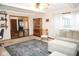 Spacious living room leads to dining room and features a china cabinet and rocking chair at 254 Bittersweet Dr, Whiteland, IN 46184
