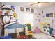 Bright playroom with colorful decor, ample play space, and a charming play kitchen at 254 Bittersweet Dr, Whiteland, IN 46184