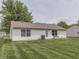View of the backyard showcasing the lawn and white siding of the house at 2756 Branigin Creek Blvd, Franklin, IN 46131