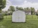 Spacious backyard features a well-maintained lawn, storage shed, and secure black chain link fence at 2756 Branigin Creek Blvd, Franklin, IN 46131